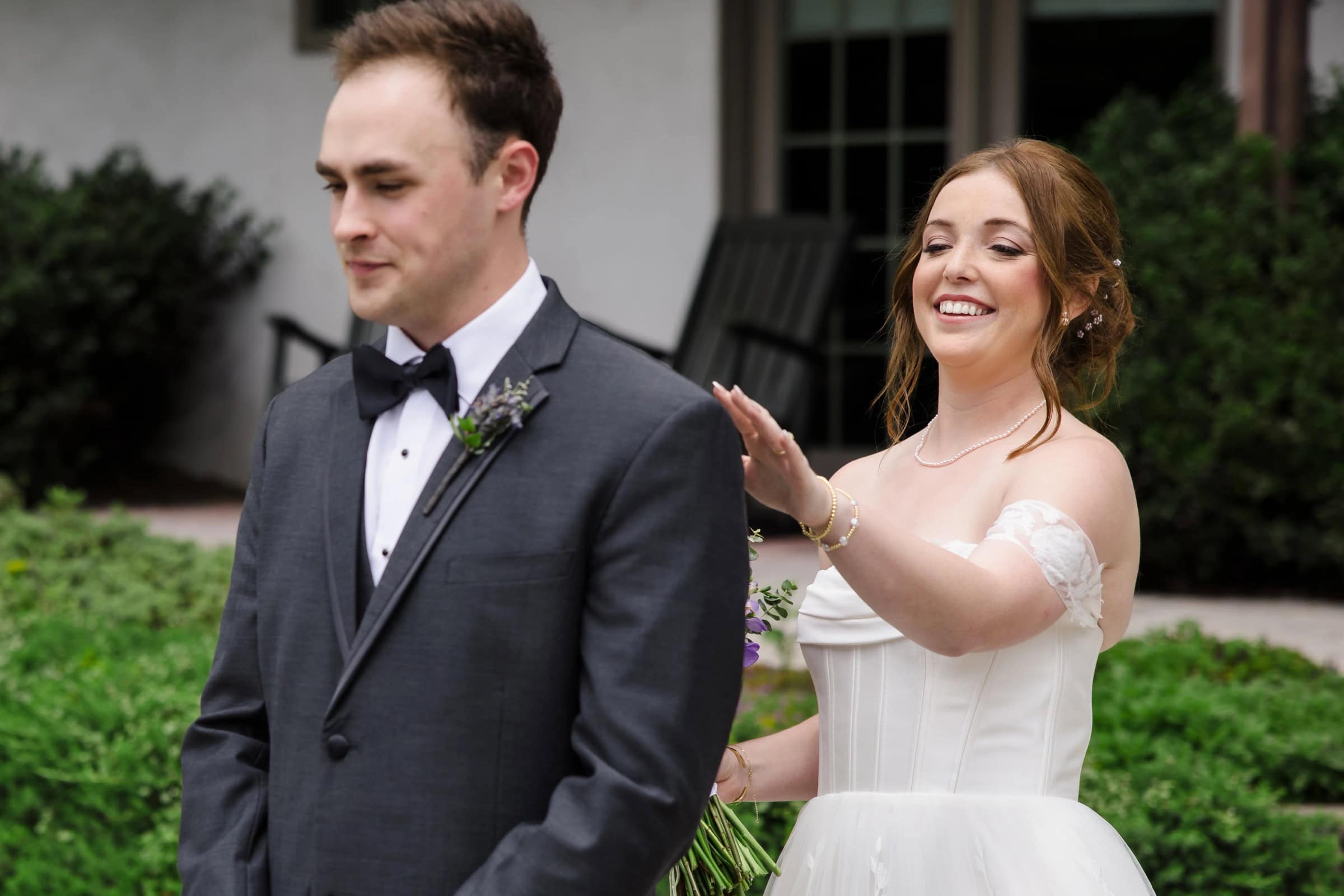 Bride and groom walking together outdoors, bride gesturing expressively while groom looks ahead. — Wedding at Glasbern Inn, Fogelsville, PA