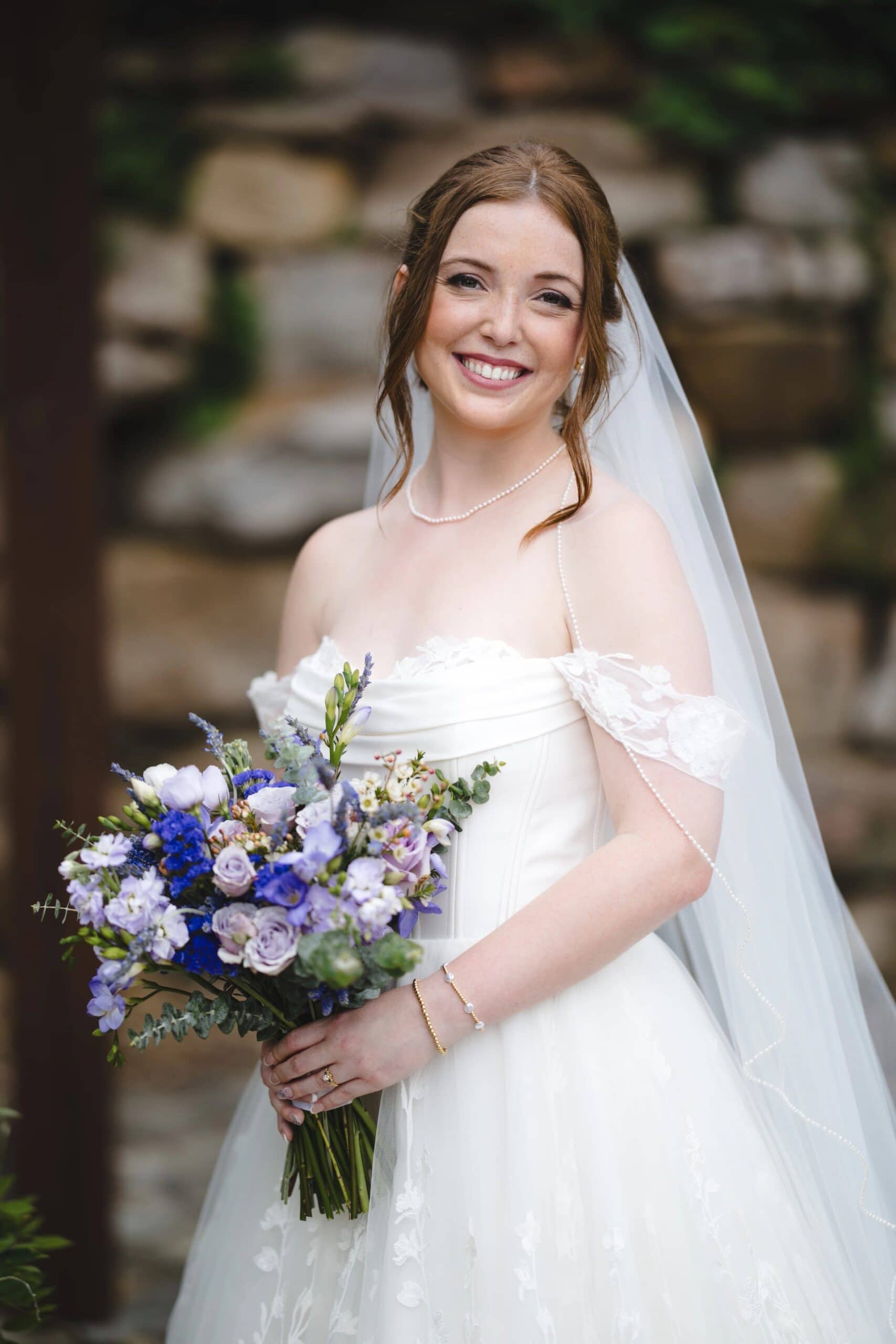 Bride standing for a formal portrait, holding her bouquet and smiling at the camera. — Wedding at Glasbern Inn, Fogelsville, PA