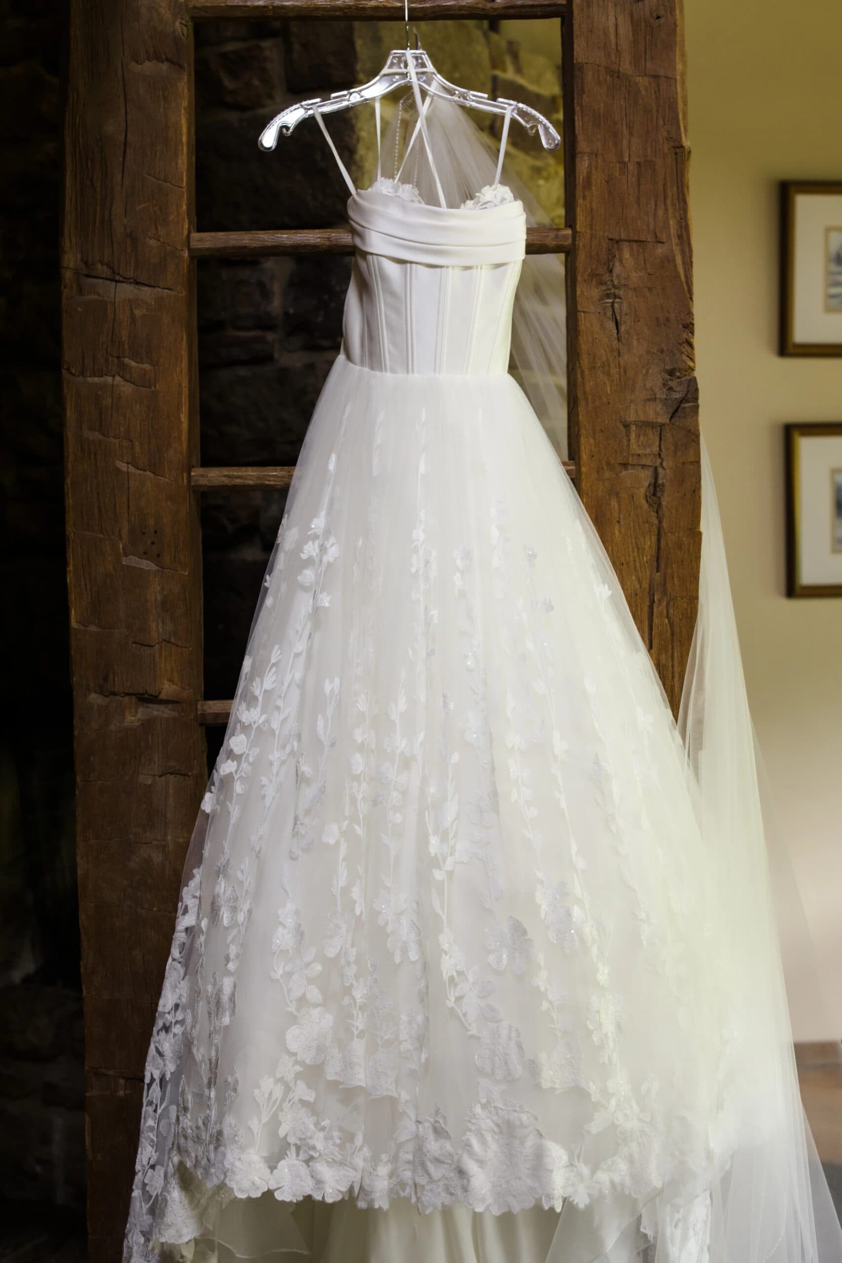 Wedding dress hanging on display before the ceremony, captured in its full formal presentation. — Wedding at Glasbern Inn, Fogelsville, PA