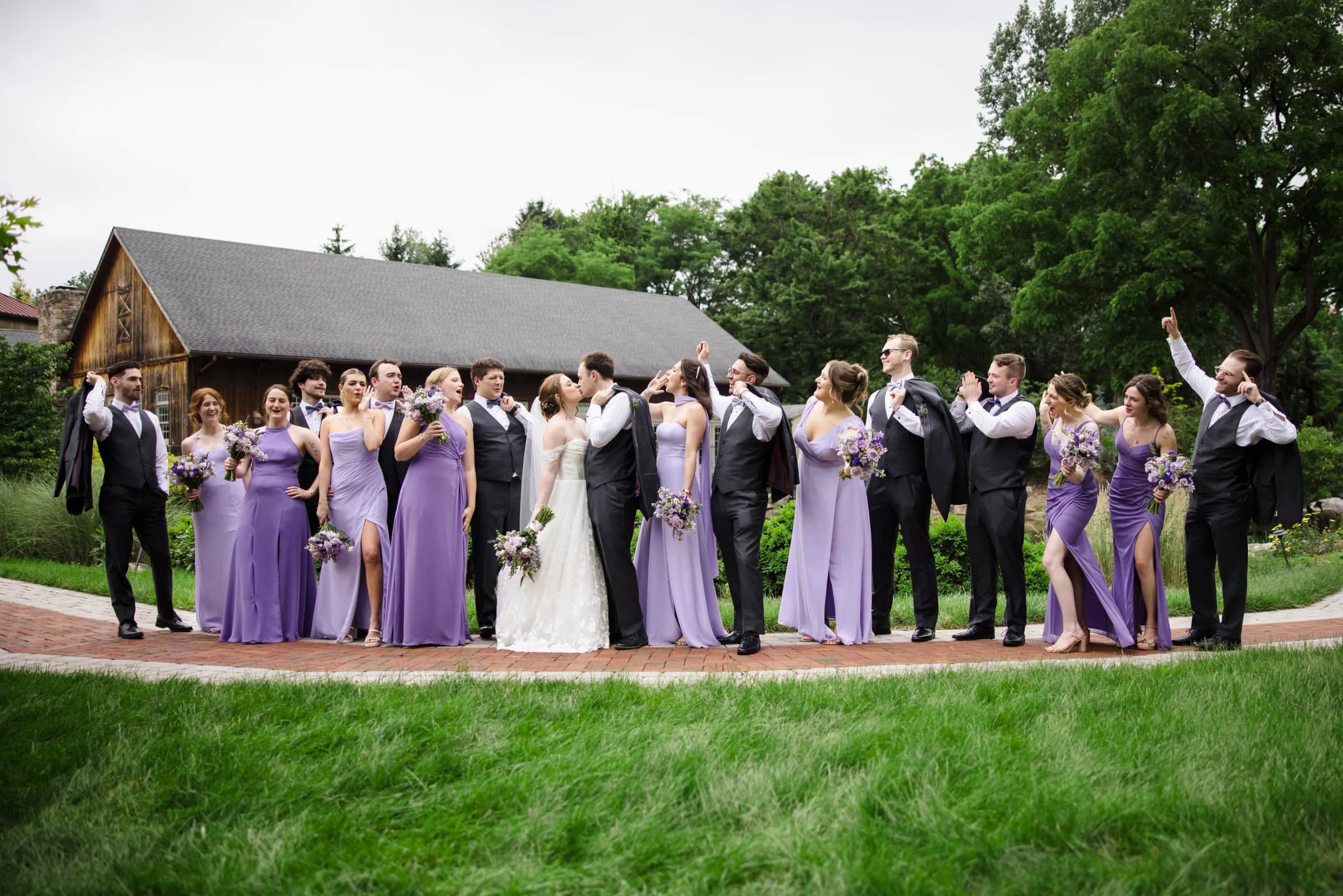 Wedding party stands in a line for a formal group portrait outside a chapel. — Wedding at Glasbern Inn, Fogelsville, PA