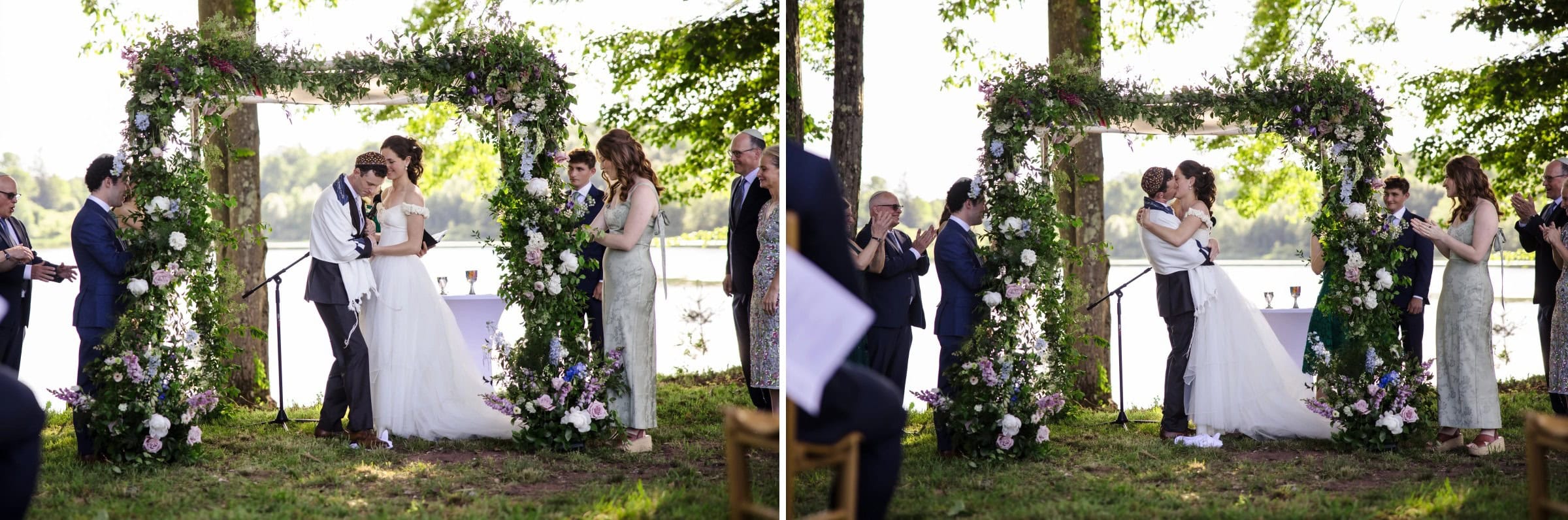 Bride and groom kissing under a floral archway during their wedding ceremony. — Wedding at Tyler Hill Camp, Tyler Hill, PA