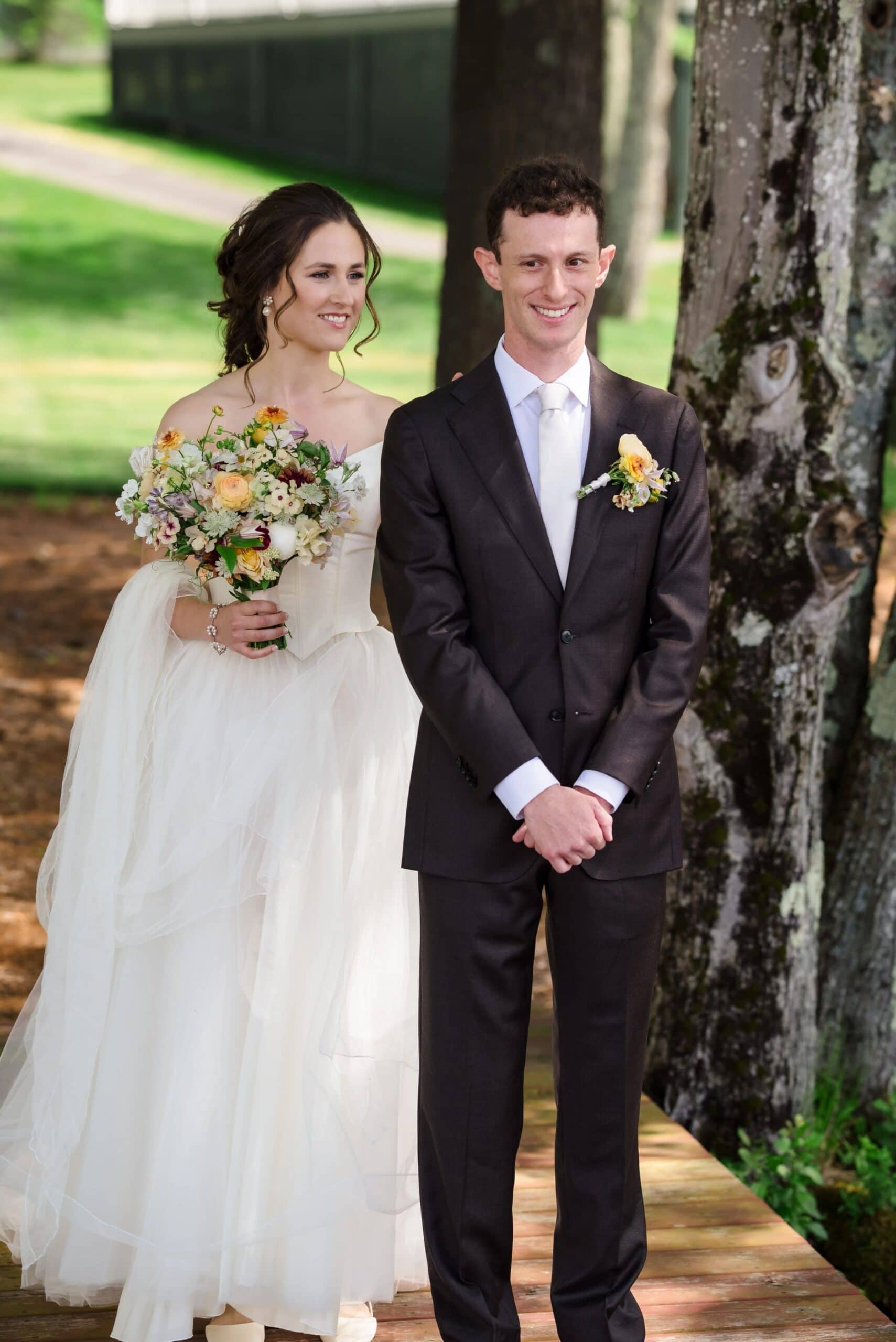 Bride and groom standing together for a formal wedding portrait beneath a large tree. — Wedding at Tyler Hill Camp, Tyler Hill, PA